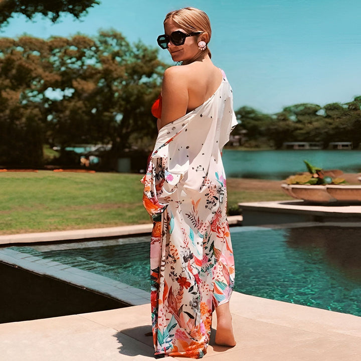 Femme portant un kimono fleuri au bord de la piscine. Kimonos pour femmes, vêtements d'été élégants et confortables. Achetez nos kimonos en ligne.
