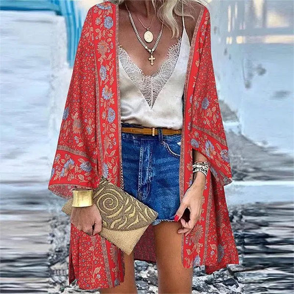 Femme portant un kimono rouge à motifs floraux. Vêtement ample, léger et tendance. Idéal pour un style bohème chic. Collection kimonos pour femmes.