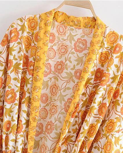 Kimono fleuri jaune et orange, vêtement de détente léger. Idéal comme peignoir ou veste d'été. Motifs floraux vintage. Disponible dans notre boutique de kimonos.