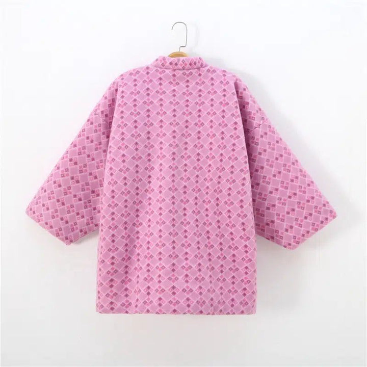 Kimono rose à motifs losanges, suspendu sur un cintre. Vêtement de style japonais.