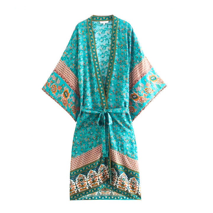 Kimono turquoise à motifs floraux, manches larges, ceinture nouée. Vêtement léger et élégant, parfait pour la superposition ou comme robe de plage. Découvrez notre collection de kimonos uniques!