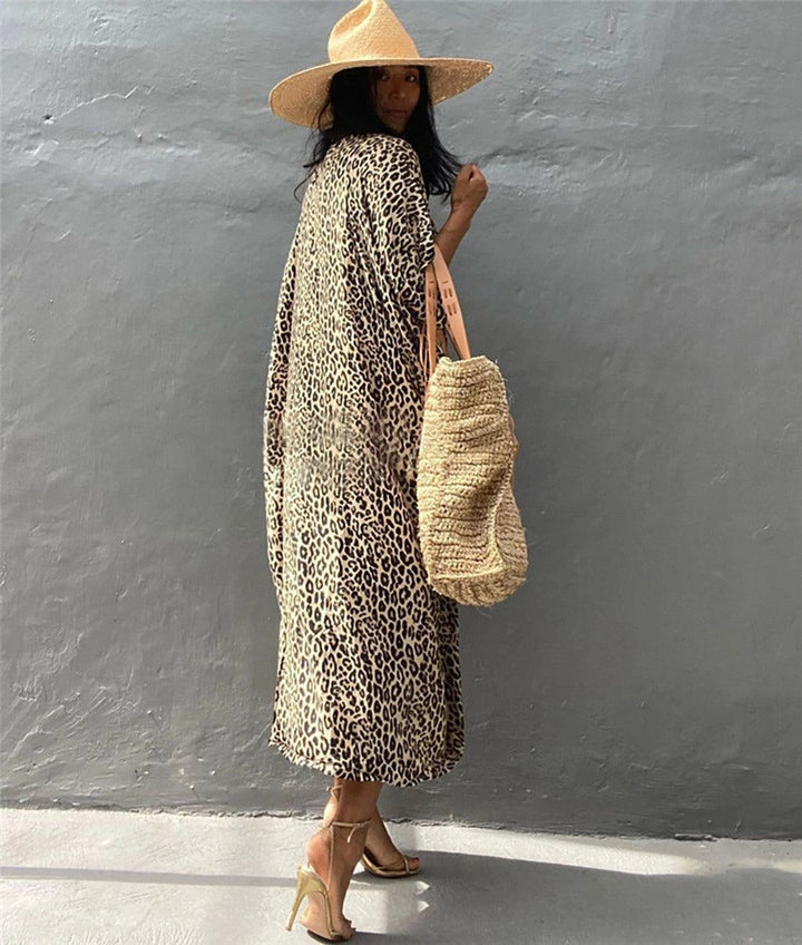 Femme portant un kimono à motif léopard, un chapeau de paille et des talons dorés. Sac en fibres naturelles. Vêtements de style kimono. Boutique de kimonos en ligne.
