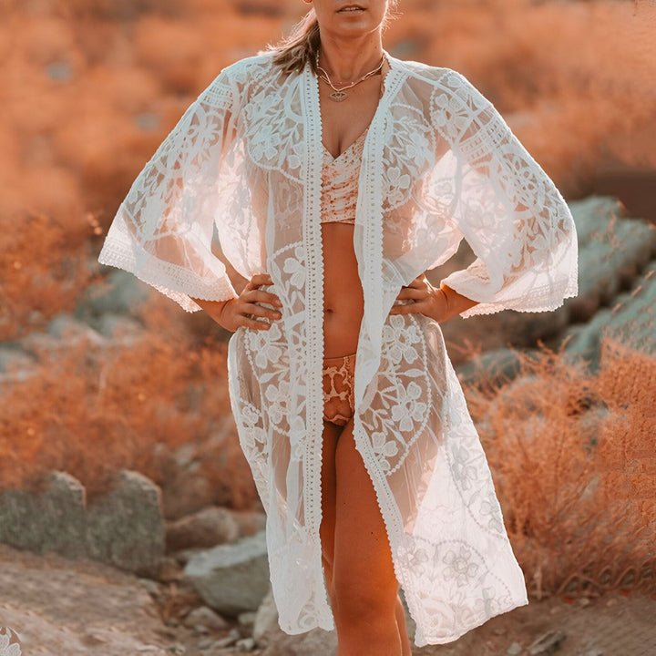 Femme portant un kimono en dentelle blanche. Kimono élégant et léger parfait pour la plage ou pour une occasion spéciale. Notre collection de kimonos offre une variété de styles et de couleurs. Achetez maintenant!