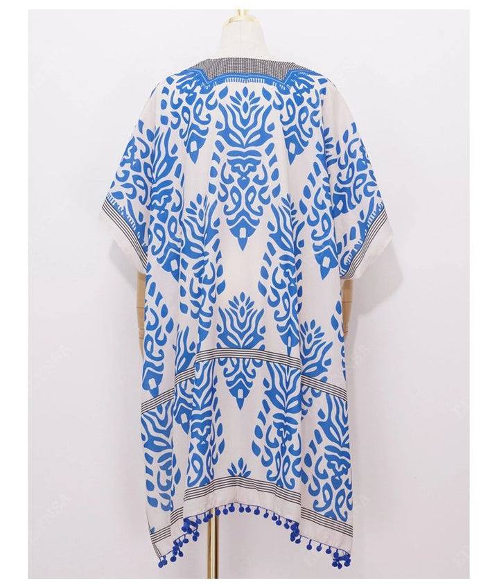 Kimono pour femme avec motifs bleus. Vêtement ample et confortable, idéal pour la plage ou la maison. Découvrez notre collection de kimonos uniques.
