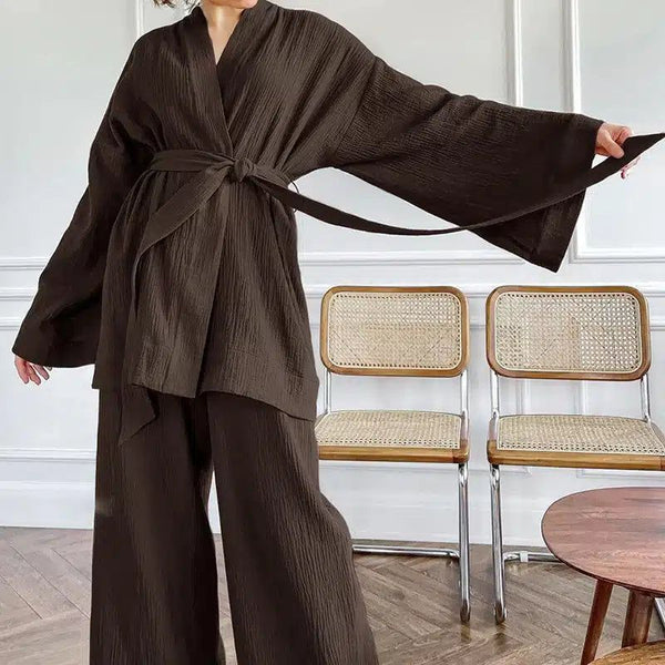 Femme portant un kimono marron avec une ceinture, faisant partie d'un ensemble décontracté. Mode kimono contemporaine pour femmes.