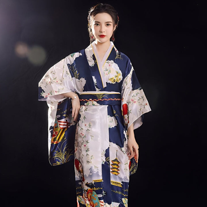 Femme portant un kimono japonais traditionnel bleu et blanc avec des motifs floraux et de paysages. Vente de kimonos authentiques.