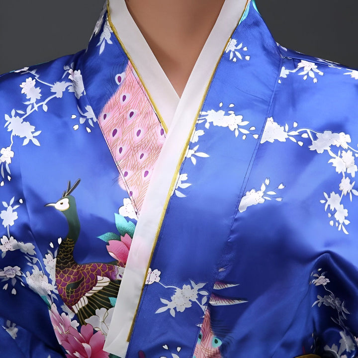 Détail d'un kimono bleu avec motifs de paon et fleurs. Vêtements traditionnels japonais. Découvrez notre collection de kimonos uniques.