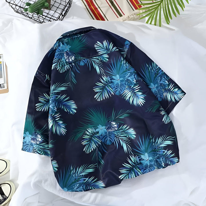 Kimono bleu marine avec motif floral tropical bleu et vert. Vêtement d'été léger et confortable, idéal pour un look décontracté et tendance. Découvrez notre collection de kimonos pour hommes.