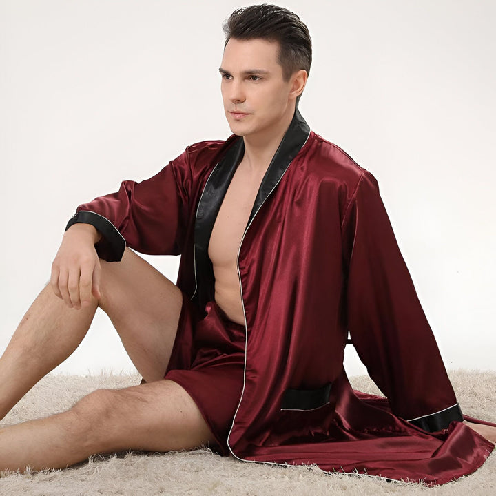 Homme portant un kimono bordeaux avec garniture noire. Peignoir en soie pour homme, vêtements de nuit confortables. Achetez nos kimonos élégants et luxueux en ligne.