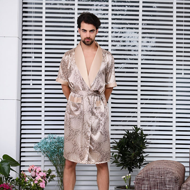 Homme portant un kimono beige et or à motifs. Kimono élégant avec col en satin, idéal pour la détente. Vêtements de détente de luxe.