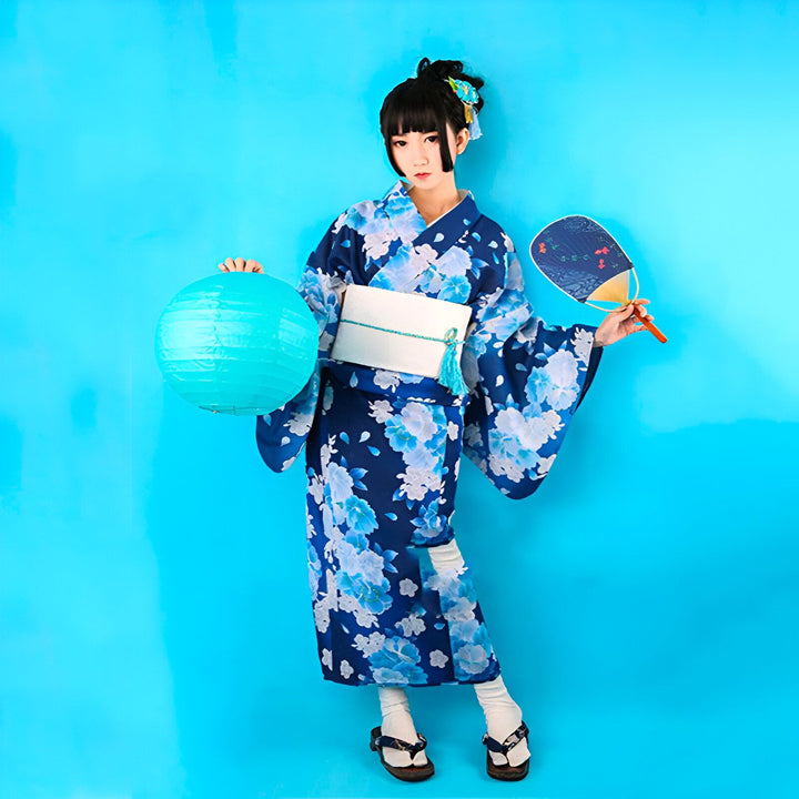 Jeune femme en kimono floral bleu et blanc, tenant une lanterne et un éventail. Collection de kimonos traditionnels japonais. Vêtements et accessoires japonais authentiques.