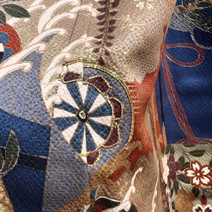 Détail de tissu de kimono japonais avec motifs traditionnels : roues, vagues et fleurs stylisées. Tissus de luxe pour kimonos.