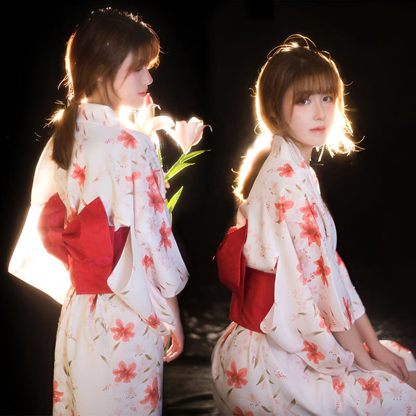 Deux jeunes femmes en kimono fleuri blanc et rouge. Gros plan sur le nœud rouge à l'arrière. Mode japonaise traditionnelle. Vente de kimonos en ligne.