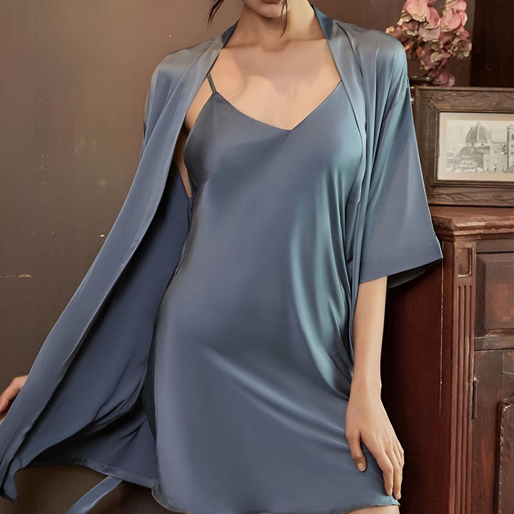 Femme portant un kimono bleu satiné avec une nuisette assortie. Vêtements d'intérieur confortables et élégants. Découvrez notre collection de kimonos de luxe.