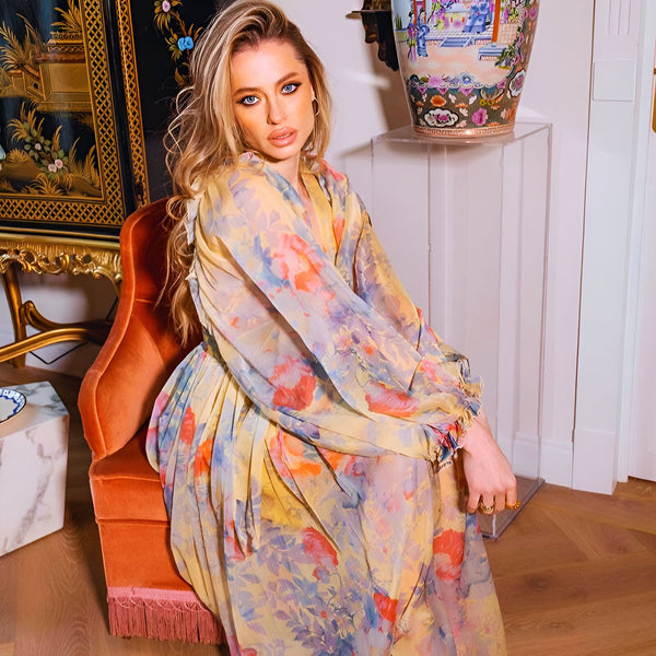 Femme blonde portant un kimono fleuri jaune et rose. Vêtements de style japonais. Kimonos de notre boutique en ligne.