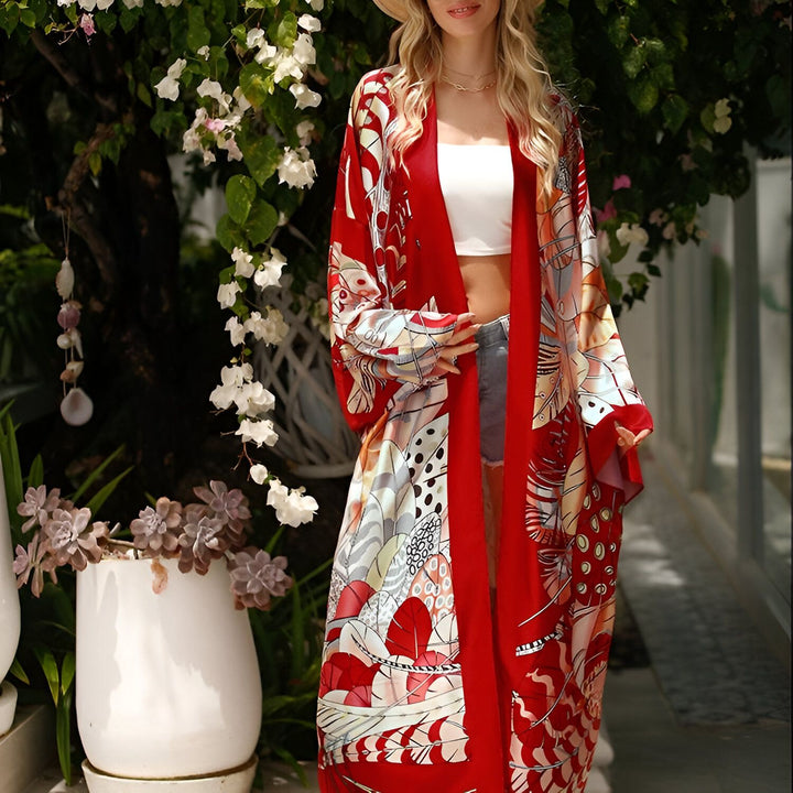 Femme portant un kimono rouge à motifs, style bohème. Vêtement de plage tendance, idéal pour l'été. Boutique en ligne de kimonos pour femmes.