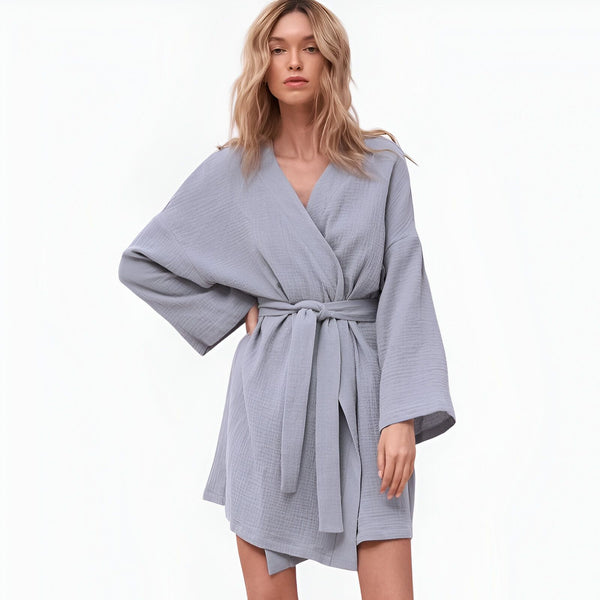 Femme portant un kimono bleu clair en coton gaufré, noué à la taille. Vente de kimonos confortables et élégants.