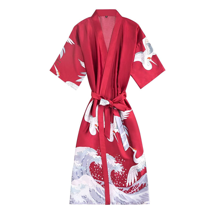 Kimono rouge avec motifs de grues blanches et vagues, ceinture nouée. Vêtement traditionnel japonais, style élégant et confortable. Parfait pour la détente à la maison.
