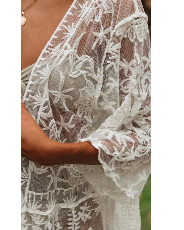 Kimono blanc en dentelle florale, manches longues. Vêtement léger et élégant, parfait pour un look bohème chic. Découvrez notre collection de kimonos.