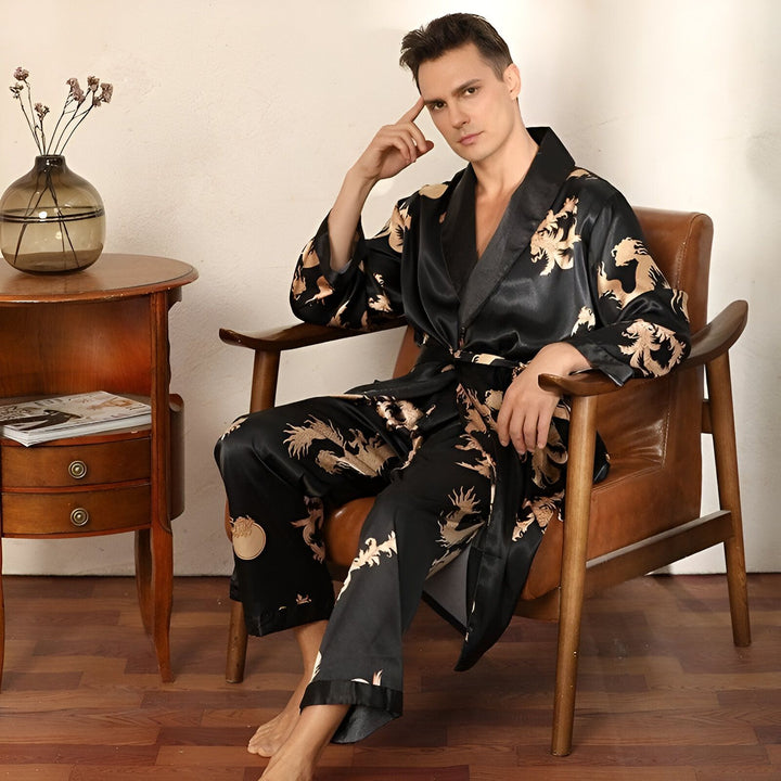 Homme assis portant un kimono noir à motifs de dragons dorés. Élégance et confort. Kimonos de haute qualité pour hommes disponibles à l'achat.