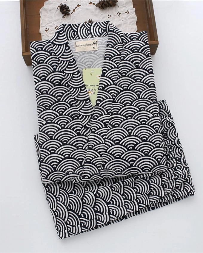 Kimono homme noir et blanc à motifs vagues, plié. Vêtement traditionnel japonais à motifs graphiques. Idéal pour se détendre avec style. Boutique de kimonos en ligne.