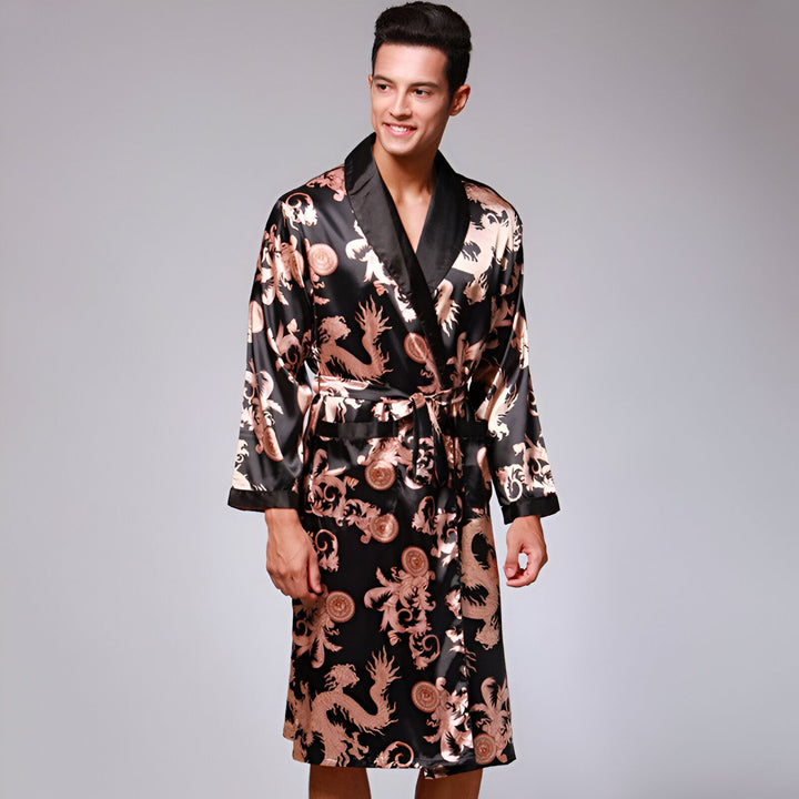 Homme souriant portant un kimono noir à motifs de dragons dorés. Vêtements de détente japonais, peignoir en soie. Notre collection de kimonos pour hommes.