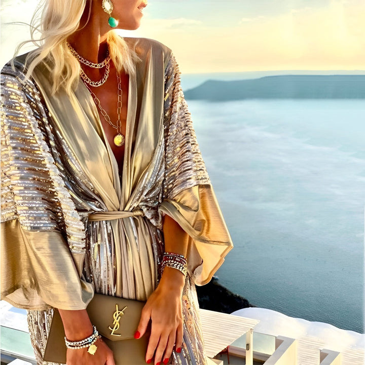 Femme portant un kimono doré étincelant avec des bijoux et un sac à main élégants. Vente de kimonos de luxe.