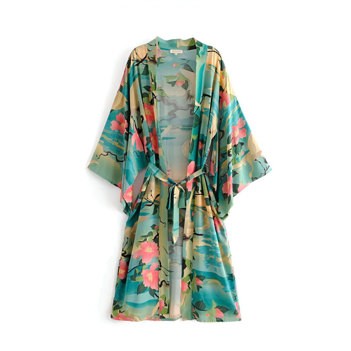 Kimono bleu turquoise à motifs floraux roses, coupe ample avec ceinture. Vêtement d'intérieur élégant et confortable. Idéal pour se détendre avec style.