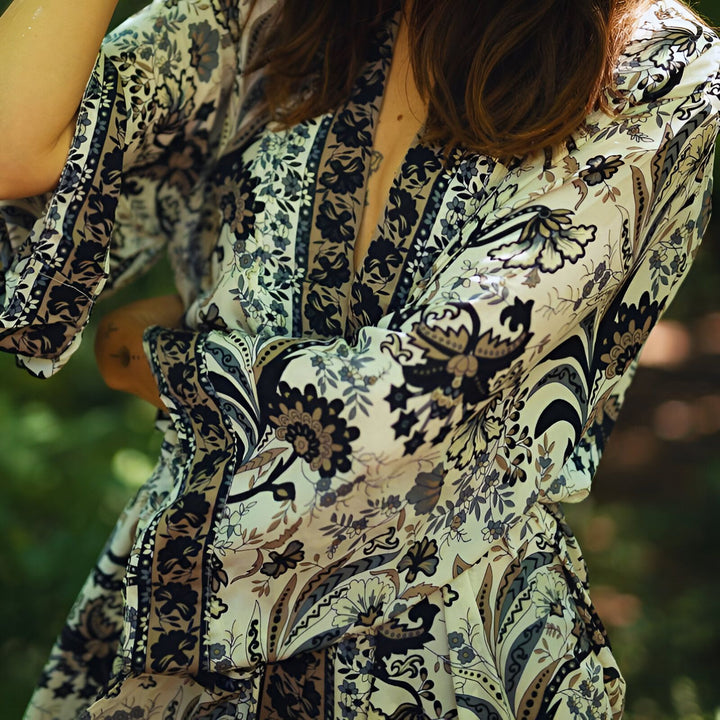 Gros plan sur un kimono fleuri blanc et noir pour femme, mettant en valeur les détails du motif et la texture du tissu. Vêtements japonais traditionnels revisités. Idéal pour un look bohème chic.