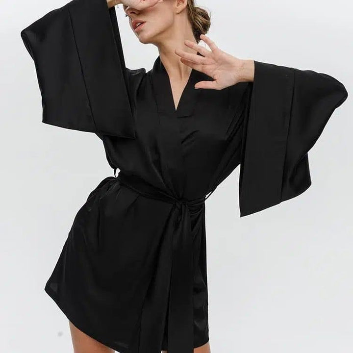 Femme portant un kimono noir en soie avec manches évasées. Vêtements d'intérieur élégants. Kimonos de qualité supérieure à vendre.