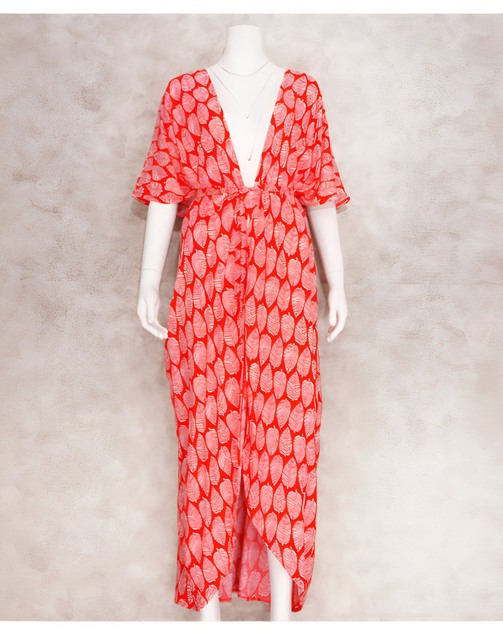 Kimono rouge à motifs feuilles blanches, présenté sur un mannequin. Vêtement ample et léger, idéal pour l'été. Découvrez notre collection de kimonos.