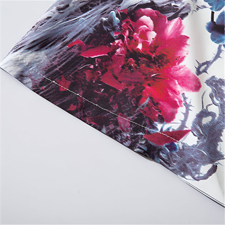 Détail d'un kimono avec motif floral rouge vif et branches bleues. Tissu de qualité, idéal pour un style japonais authentique. Découvrez notre collection de kimonos uniques !