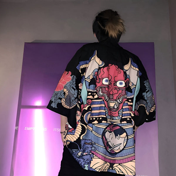 Kimono noir avec un motif de démon rouge et bleu, vendu par notre boutique. Vêtements japonais traditionnels et modernes. Découvrez nos collections de kimonos uniques.