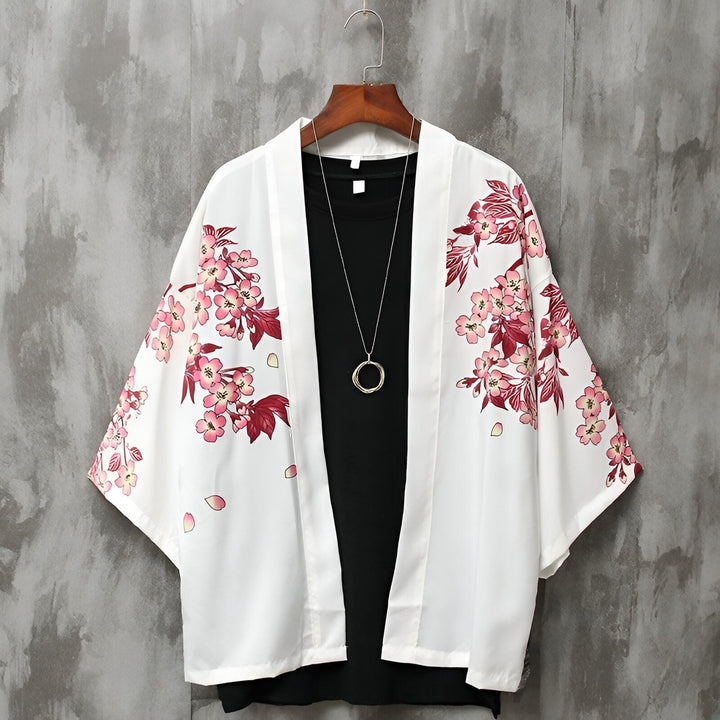 Kimono blanc à fleurs roses suspendu. Vêtement traditionnel japonais revisité. Idéal pour un look tendance et confortable. Découvrez notre collection de kimonos uniques.