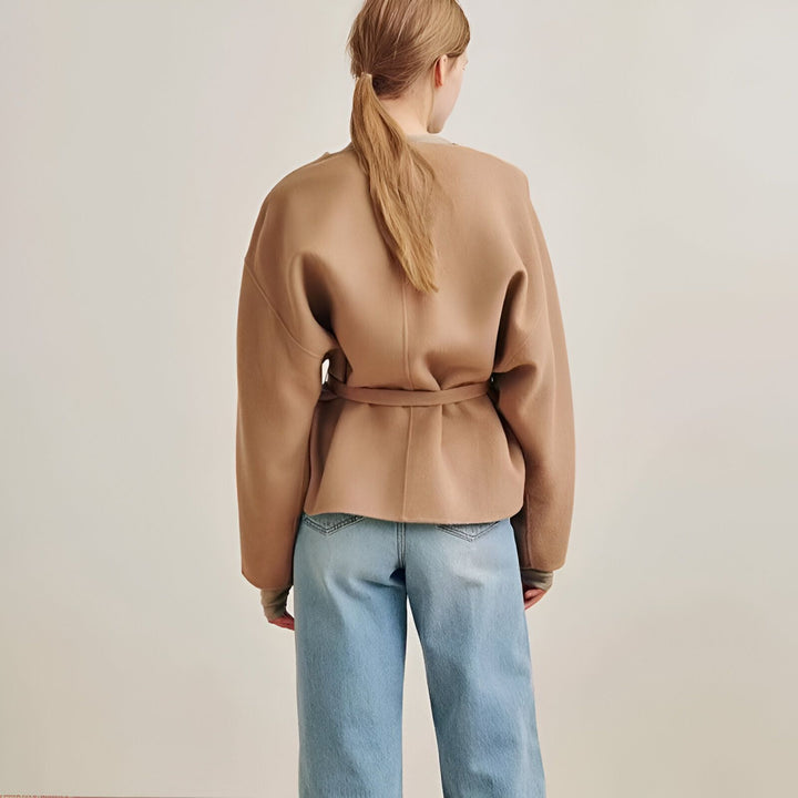 Dos d'une femme portant un kimono marron court avec une ceinture, associé à un jean bleu. Découvrez notre collection de kimonos uniques.