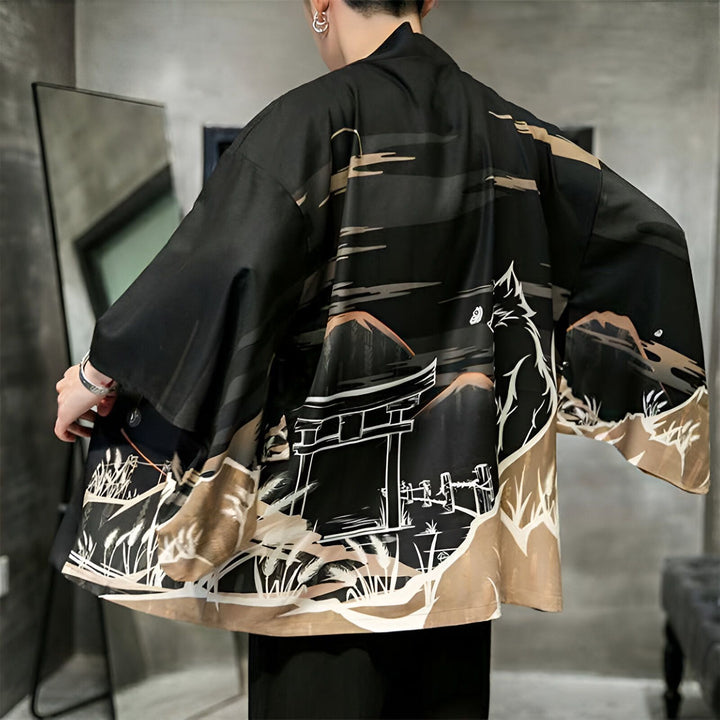 Dos d'un homme portant un kimono noir avec des motifs japonais : montagnes, porte traditionnelle et chat blanc. Kimono tendance pour homme. Vêtements traditionnels japonais à la vente.