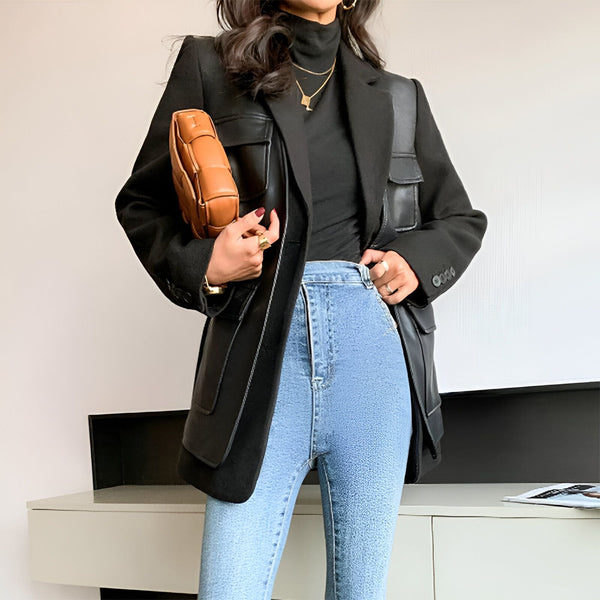 Femme portant un kimono veste noire avec des poches en cuir, un col roulé noir et un jean bleu. Sac à main en cuir marron. Mode kimono pour femmes.