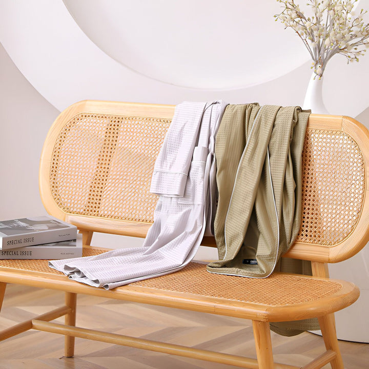 Deux kimonos en coton gaufré sur un banc en rotin. Vente de kimonos confortables pour la maison.