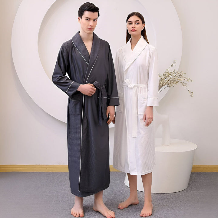 Couple en kimonos assortis. Lui en kimono long gris anthracite, elle en kimono blanc léger. Collection de kimonos pour la maison, confort et élégance.