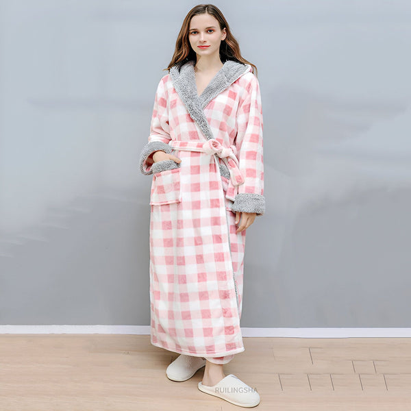 Femme portant un kimono long à carreaux roses et blancs, avec capuche et bordure en fausse fourrure grise. Peignoir doux et confortable, idéal pour se détendre à la maison. Vêtements de nuit kimono à vendre.