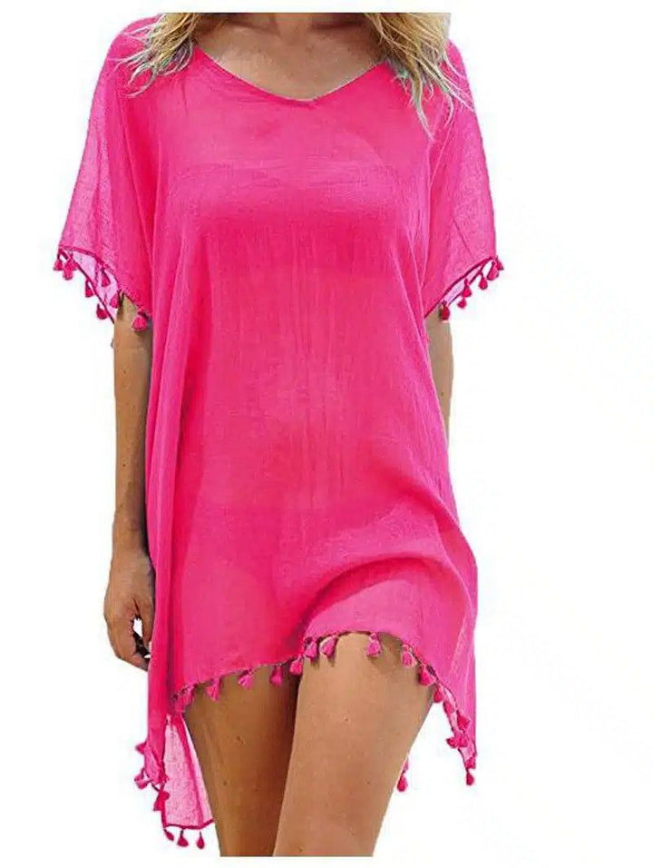 Kimono de plage rose vif avec détails de pompons. Idéal pour compléter votre look estival. Découvrez notre collection de kimonos.