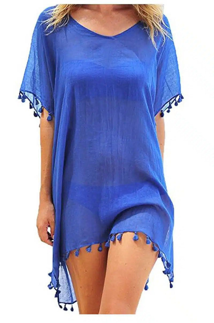 Kimono de plage bleu orné de pompons, parfait pour compléter votre tenue estivale. Découvrez notre collection de kimonos pour un style unique et tendance.